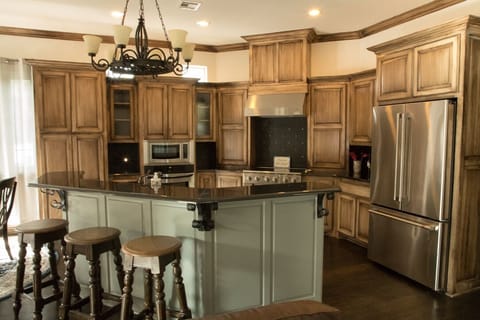 Upstairs kitchen with granite counters and stainless steel appliances.