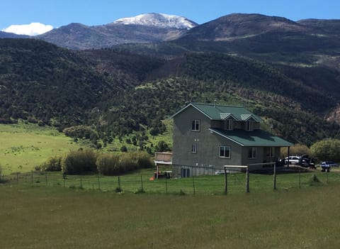 Home and Deck surrounded by 1 acre of lawn.