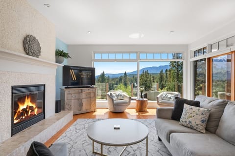 Living room, located on the top (3rd) floor, with mountain views, cozy seating and a fireplace.