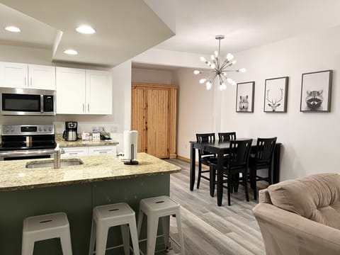 Kitchen, dining area, den with murphy bed