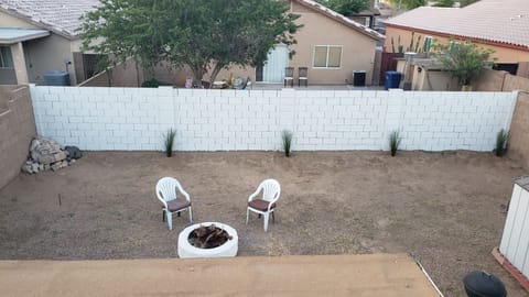 Backyard  looking down. It is in the remodeling stage. Has horseshoe game space