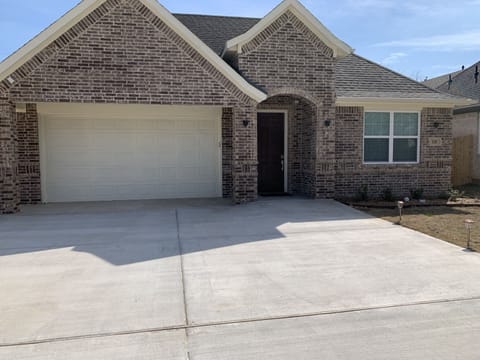 House frontage with several cars parking space 