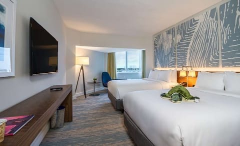 Settle in with a roomy layout, large TV, and calm tones.