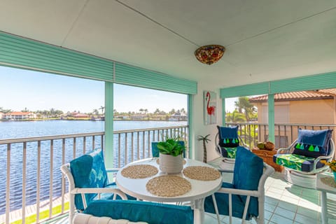 Relax on the covered balcony overlooking serene waterfront views.