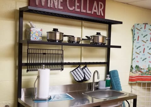 Stocked kitchenette with sink.