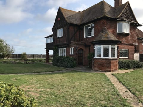 Large corner plot with wrap around garden and stunning sea views.