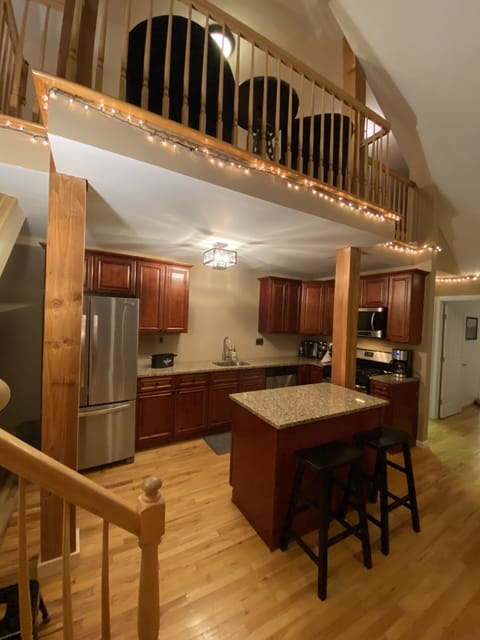 Open Kitchen with cherry cabinets, granite counters and stainless appliances