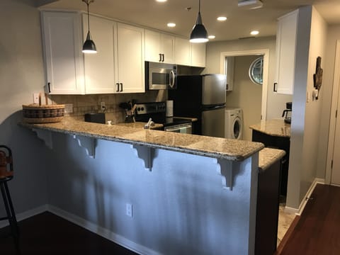 Fully Stocked Kitchen and adjacent Washer/Dryer