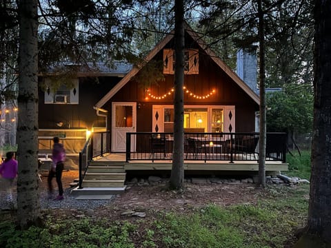 Summer evening view of the front of the chalet and new deck.