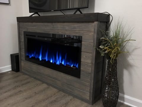 Main level living room fireplace and television