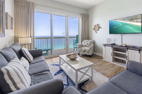 Unwind in your oceanfront living room where floor-to-ceiling windows frame endless sea views and plush seating invites relaxation.