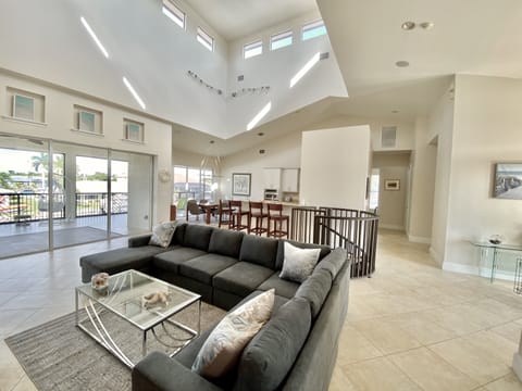 Lounge has sliding doors to the grand screened lanai porch with multiple seating