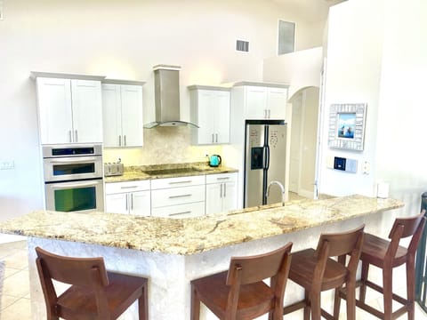 Upstairs kitchen, fully equipped with 4 barstools and view of canal
