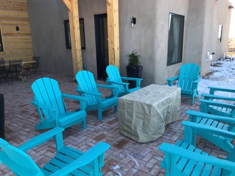 NM blue Adirondacks, circled around fire pit (in rain coat)