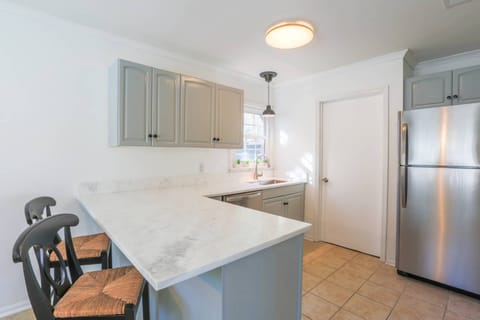 The kitchen features stainless steel appliances and beautiful countertops.