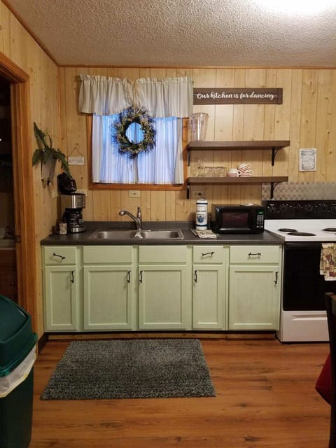 Fully equipped kitchen with stove, full size refrigerator, coffee maker, dishes