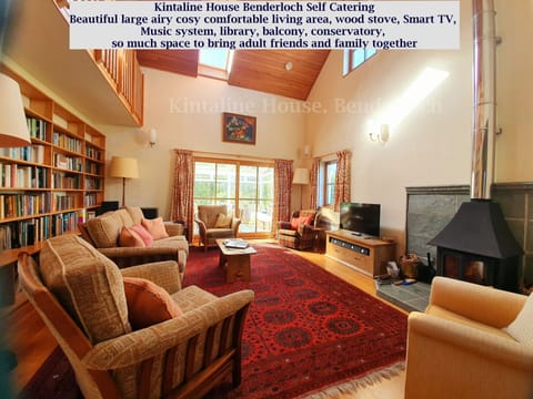 double height large living space, woodstove, free firewood, library, comfortable