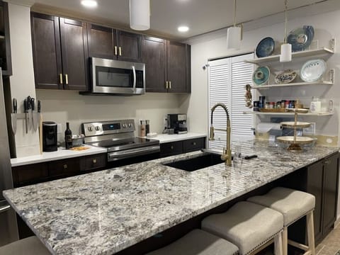 Kitchen with granite counter-tops and seating.