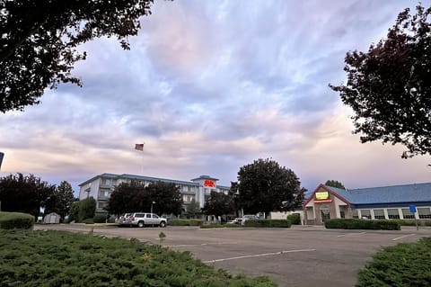 Arrive at sunset to a calm, spacious parking area.