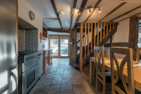 main house kitchen dining with fully fitted kitchen and doors out to the patio