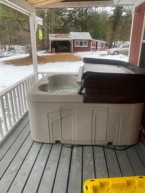 Hot Tub Retreat: Unwind in the bubbling warmth while enjoying serene river and woodland views!