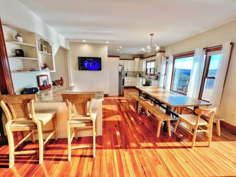 The open kitchen is well stocked & has a view to enjoy. 1 of the 3 Smart TVS.