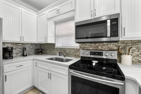 Microwave, oven,  dishwasher, 12 cup coffee maker, wine opener, spice rack, air fryer & toaster in the pantry for your use.