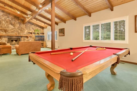 Upstairs game room with pool table and cozy family space, perfect for fun, relaxation, and memorable guest gatherings
