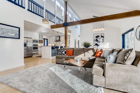 Living room with high ceilings and view of upstairs and loft area