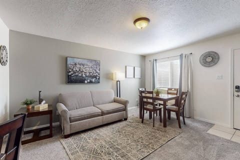 Living room with table to be used to have meals at or use to set up a work station