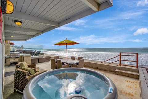 Relaxing oceanfront patio with a hot tub.