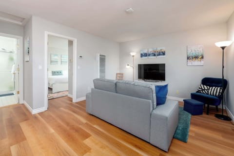 We start our home tour with a look at the bright living area, complete with a comfy couch and a smart TV.