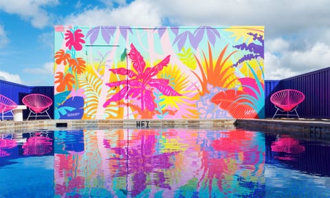 Dive into a vibrant pool oasis with mural views.