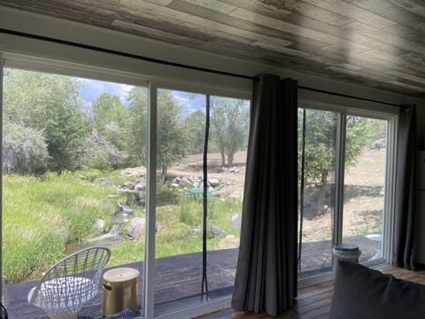 living room kitchen views looking north over deck and creek