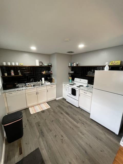 Modern kitchen with dishwasher, oven, microwave, and Refrigerator. 