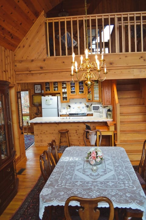 A formal dining room table overlooks the den's fireplace, and kitchen keeping the whole family involved in a "great room"