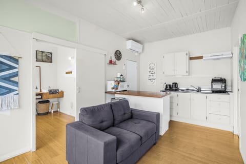 Photo of the lounge, kitchenette to the right of the couch.