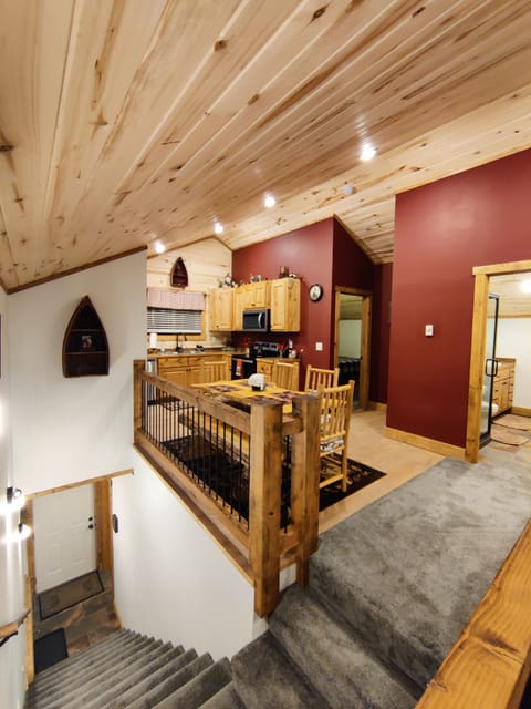 A view of the stairway coming from the back door and also showcasing the layout.