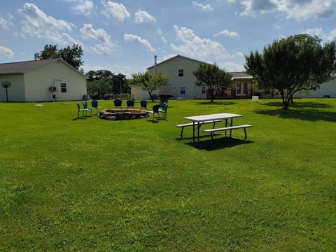EXTERIOR: The shared outdoor bonfire ring and picnic table at the property.