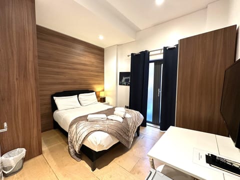 A double room with private bathroom and balcony, featuring a standard double bed for comfort.
