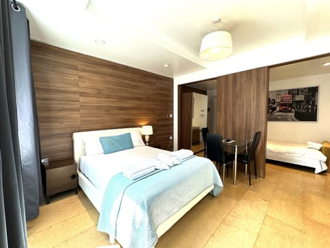 A family room with private bathroom, double bed, sofa bed, and kitchen, ideal for up to three guests.