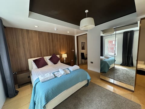A family room with private bathroom, double bed, sofa bed, and kitchen, ideal for up to three guests.