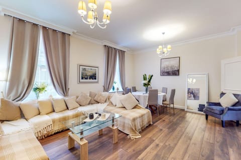 Bright living area in the Three-Bedroom Apartment with comfortable seating and smart TV