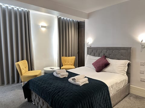 Comfortable spacious studio for two guests featuring a kitchenette, private bathroom, double bed, and cleanliness.
