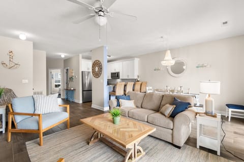 Unwind in this airy, coastal-chic living space where soft blues and natural textures create your perfect retreat sanctuary.
