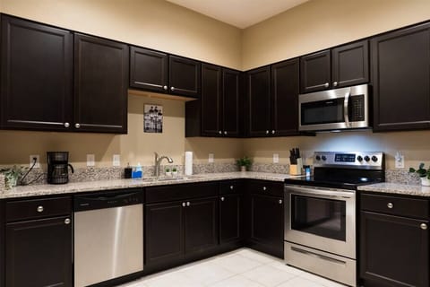 Kitchen w/ granite countertops and stainless steel appliances