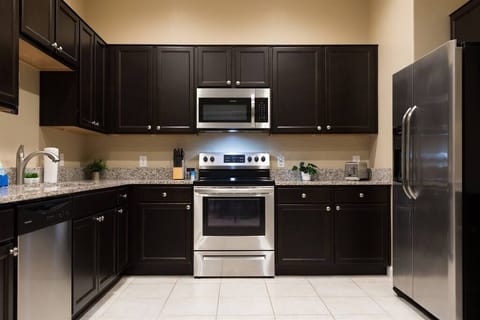 Kitchen w/ granite countertops and stainless steel appliances