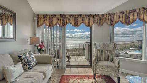 Enjoy sweeping ocean views from the cozy living room, complete with plush seating ideal for lounging and taking in the scenery.
