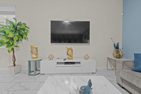 Sink into your plush sofa and enjoy movie nights on the wall-mounted TV in this stylishly decorated living space.