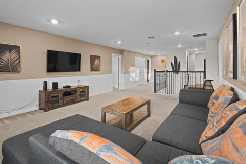 Your spacious loft lounge features plush seating, warm wood accents, and entertainment center - perfect for unwinding with loved ones.